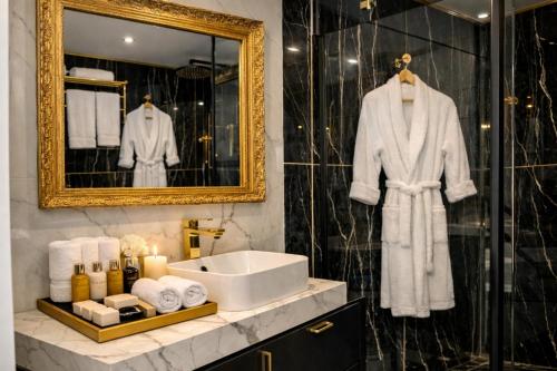 a bathroom with a sink and a mirror at Luxury Maubourg - Vue mer - Croisette 50m plage - Clim - terrasse in Cannes