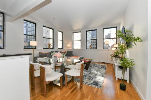 a dining room and living room with a table and chairs at Luxury 3 Bedroom Retreat in Downtown Manhattan in New York