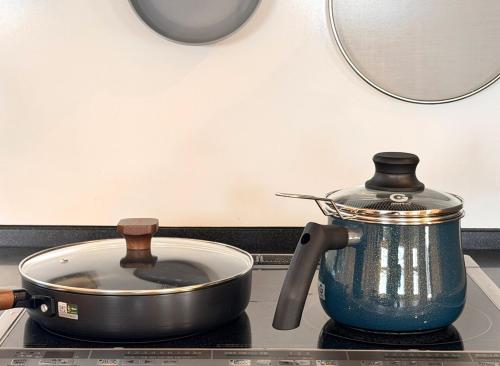 a pot and a tea kettle on a stove at The Bear ベアSpacious Holiday Villa in Inzai