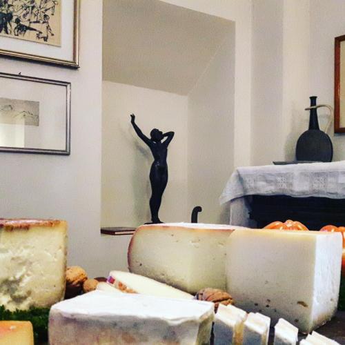 a room with cheeses and a statue of a person on the wall at Bella di Ceciliano in Arezzo