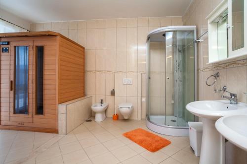 a bathroom with a toilet and a shower and a sink at Royal Villas in Dobra Voda