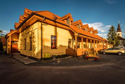 a house with a car parked in front of it at Rezort u Bobiho in Nový Tekov