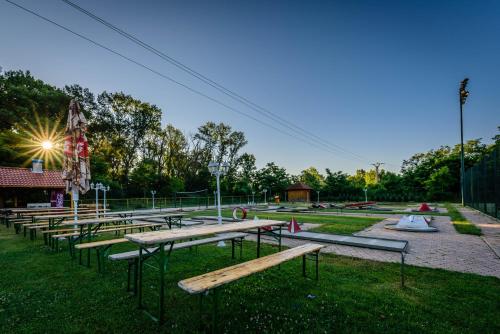 a row of picnic tables in a park at Rezort u Bobiho in Nový Tekov