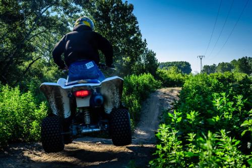 a person riding a four wheeler on a dirt road at Rezort u Bobiho in Nový Tekov
