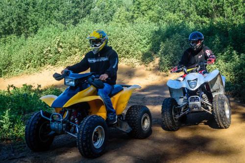 two people riding on atvs on a dirt road at Rezort u Bobiho in Nový Tekov