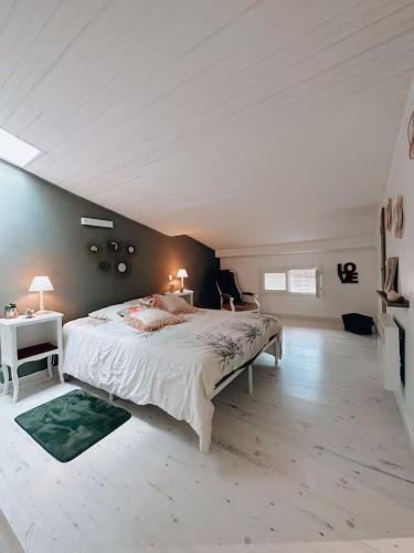 a bedroom with a large bed with two lamps on it at Duplex de Charme en Provence, Vue Imprenable in Bargemon