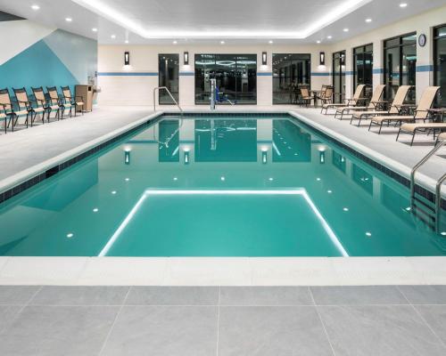 a swimming pool with blue water in a building at Hyatt Place Allentown - Lehigh Valley in Allentown