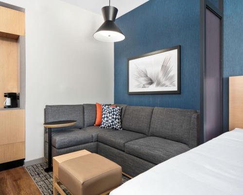 a living room with a couch and a table at Hyatt Place Allentown - Lehigh Valley in Allentown