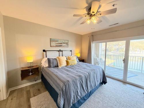 a bedroom with a bed and a ceiling fan at Lakeside Sunrise Water Views in Camdenton