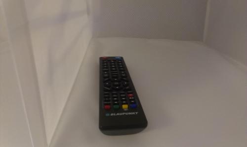 a remote control sitting on top of a table at Budanest Apartments in Budapest