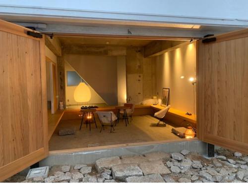 a view of a room with a table and chairs at ALY HOTEL See Sea Son in Kure