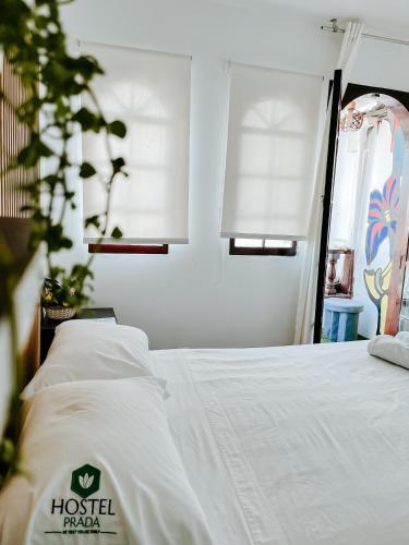 a bedroom with a bed and a window at Hostel Prada in Lima