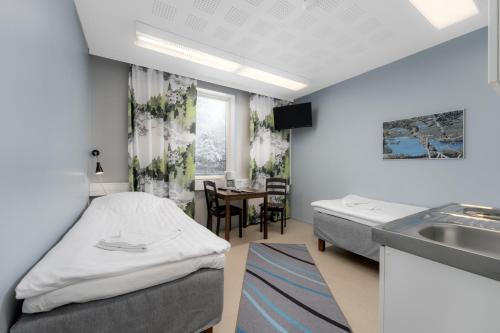 a hospital room with a bed and a sink at Jääskän Loma Hostelli Antin Tupa in Härmä
