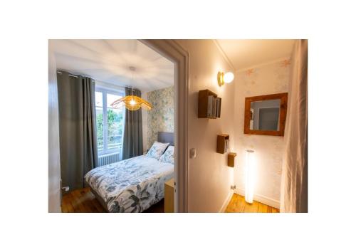 a small bedroom with a bed and a mirror at Chez Fabienne et Olivier, chambre privative avec SDB et WC, Avranches Baie du Mont Saint Michel in Avranches