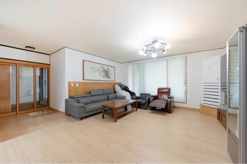 a living room with a couch and a table at Jeonju Dalbitsori Pension in Jeonju