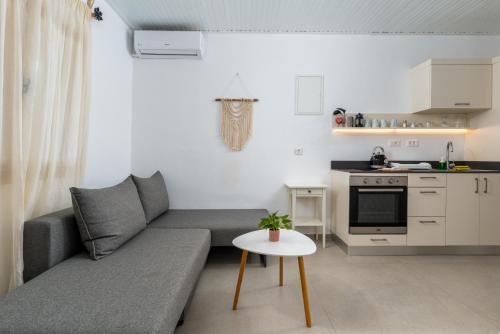 a small living room with a couch and a table at Stay in Falassarna Rooms & Apartments in Falasarna