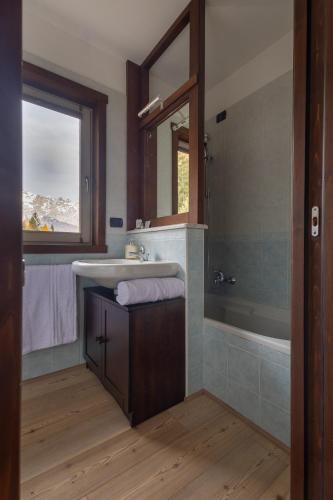 a bathroom with a sink and a mirror at Oga View Apartment in Oga