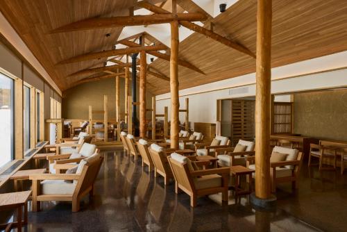 a dining room with wooden tables and chairs at AZUMA FARM Koiwai in Shizukuishi