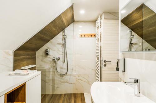 a bathroom with a shower and a sink at Apartments CRYSTAL AURA in Bohinj