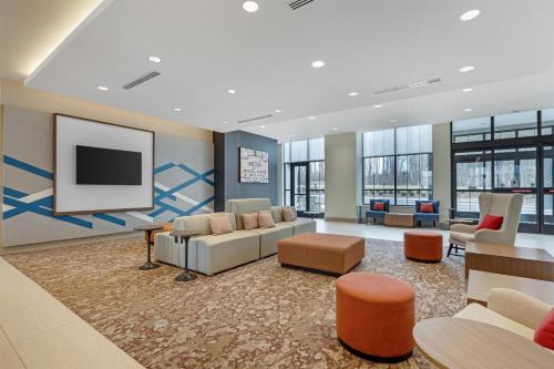 a lobby with couches and a flat screen tv at Hilton Garden Inn Media in Media