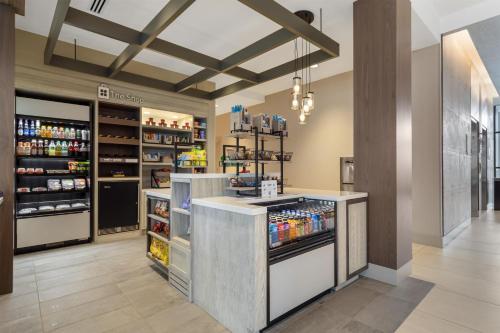 a grocery store with a refrigerator and shelves of drinks at Hilton Garden Inn Media in Media