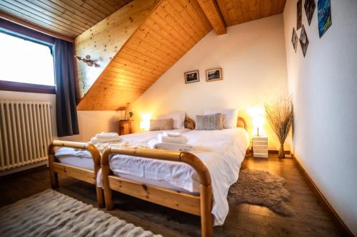 a bedroom with a large bed in a attic at Hôtel Restaurant du Marchairuz in Le Brassus