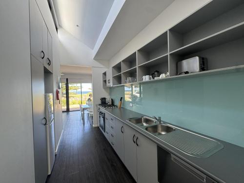 a kitchen with a sink and a counter top at Esperance Waterfront Apartment in Esperance