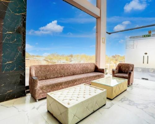 a living room with a couch and a chair at Hotel Aroma Regency in Meerut