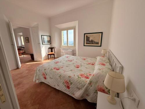 a bedroom with a bed with a floral bedspread at Suite Agli Spaldi in Iesi