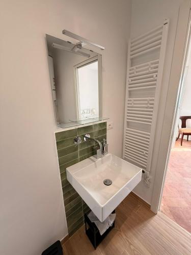 a bathroom with a white sink and a mirror at Suite Agli Spaldi in Iesi