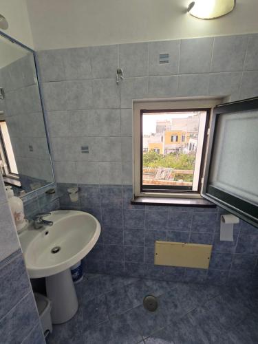 a bathroom with a sink and a window at Dany House in Atrani