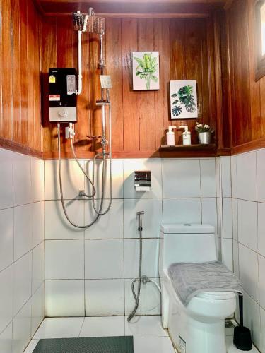 a bathroom with a shower and a toilet at Rang Robin Farmstay with swimming pool in Ban Wang Muang