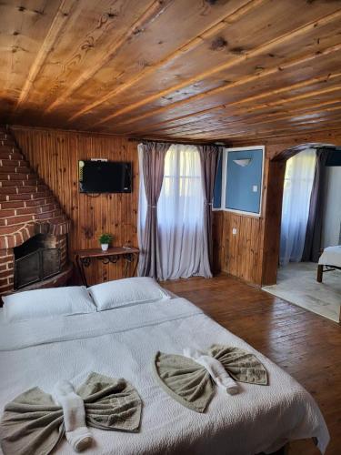a bedroom with a bed with bows on it at Old House - Стара Къща in Koprivshtitsa