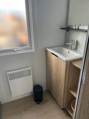 a bathroom with a sink and a window at domaine de litteau in Litteau