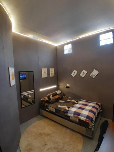 a bedroom with a bed and a mirror on the wall at Residence 168 in Gununganjar