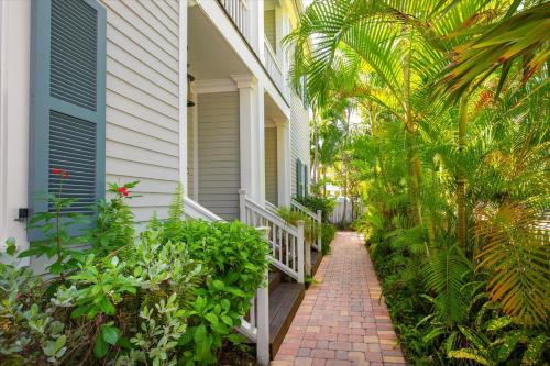 a house with a brick walkway next to a house at Palm Royale Windsor Townhomes in Key West