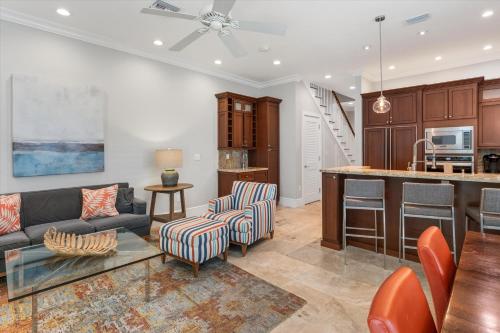 a living room with a couch and a kitchen at Palm Royale Windsor Townhomes in Key West