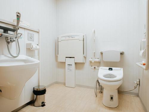 a bathroom with a toilet and a sink at Kanazawa Kokusai Hotel in Kanazawa