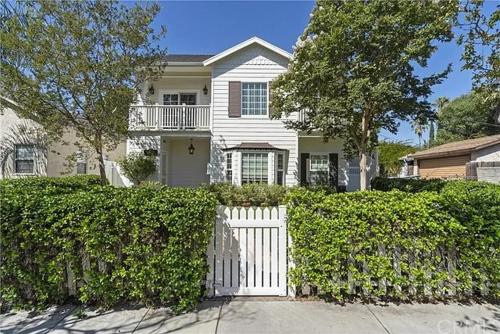 a white house with a white fence and bushes at Private room with Fridge - Mini Mansion in Burbank