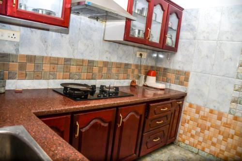 a kitchen with a stove and a counter top at Radiance Crystal in Pondicherry