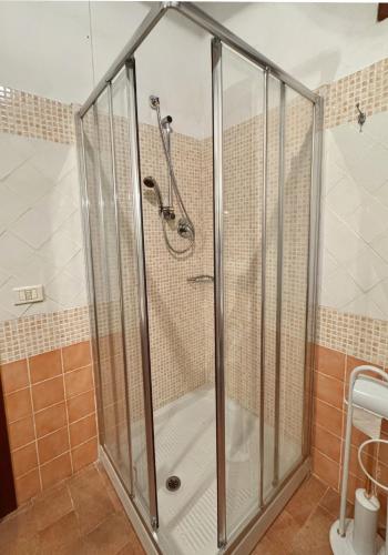 a shower with a glass enclosure in a bathroom at La torre del cappellaio in Fabriano