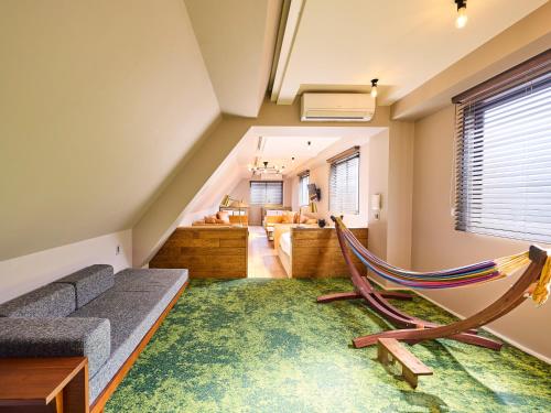 a living room with a couch and a hammock at Hotel Vintage Tokyo Kagurazaka in Tokyo