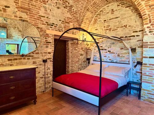 a bedroom with a bed in a brick wall at La torre del cappellaio in Fabriano
