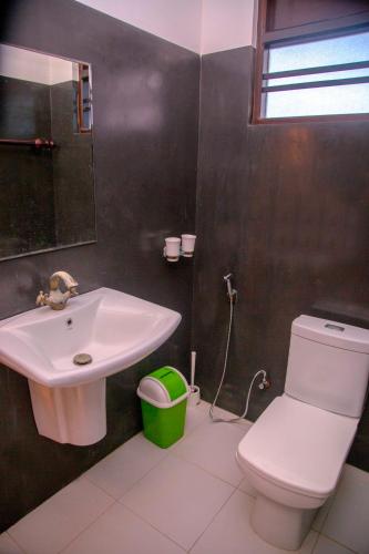 a bathroom with a white toilet and a sink at Wagon Wheel Inn in Busse