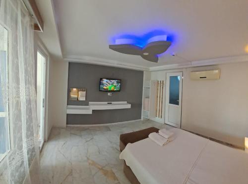a bedroom with a bed and a tv on the ceiling at Sun Rose Pansiyon in Pamukkale