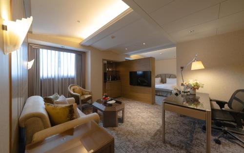 a large hotel room with a living room at The Landis Taipei in Taipei
