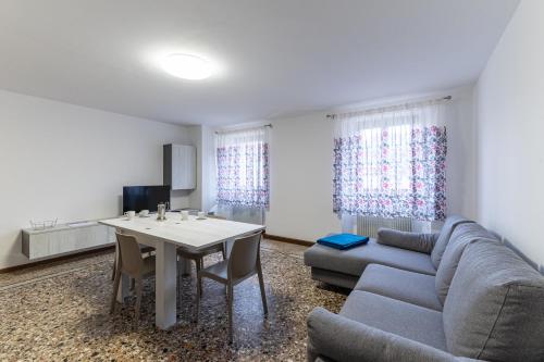 a living room with a couch and a table at La Cort di Vigje 2 in Ovaro