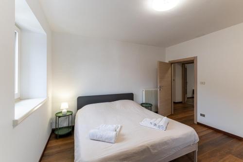 a bedroom with a bed with two towels on it at La Cort di Vigje 2 in Ovaro