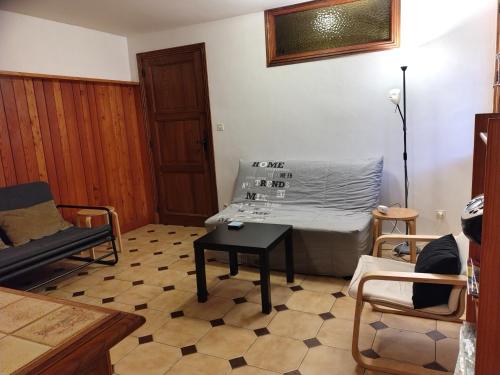 a living room with a couch and a table at 6 Bis La Capelette in Ax-les-Thermes