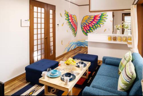 a living room with a blue couch and a table at Wave House Kujukuri Fujishita Near Kujukuri beach- Self Check-In Only in Kujukuri